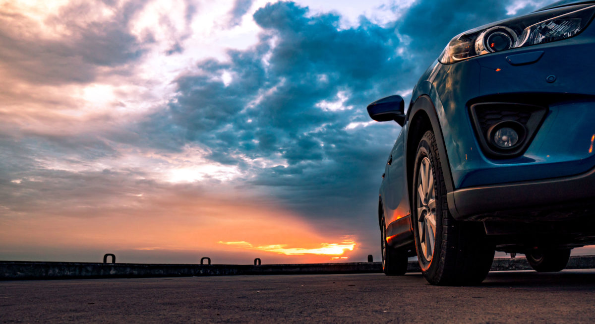 shot of car with dramatic sky - car title loan process concept image